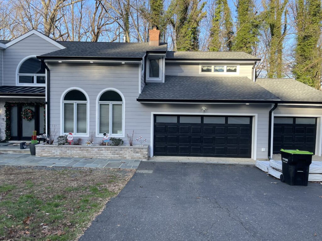 Gray residential home with arched windows, featuring residential window tinting by TintProsNJ in Monmouth County NJ
