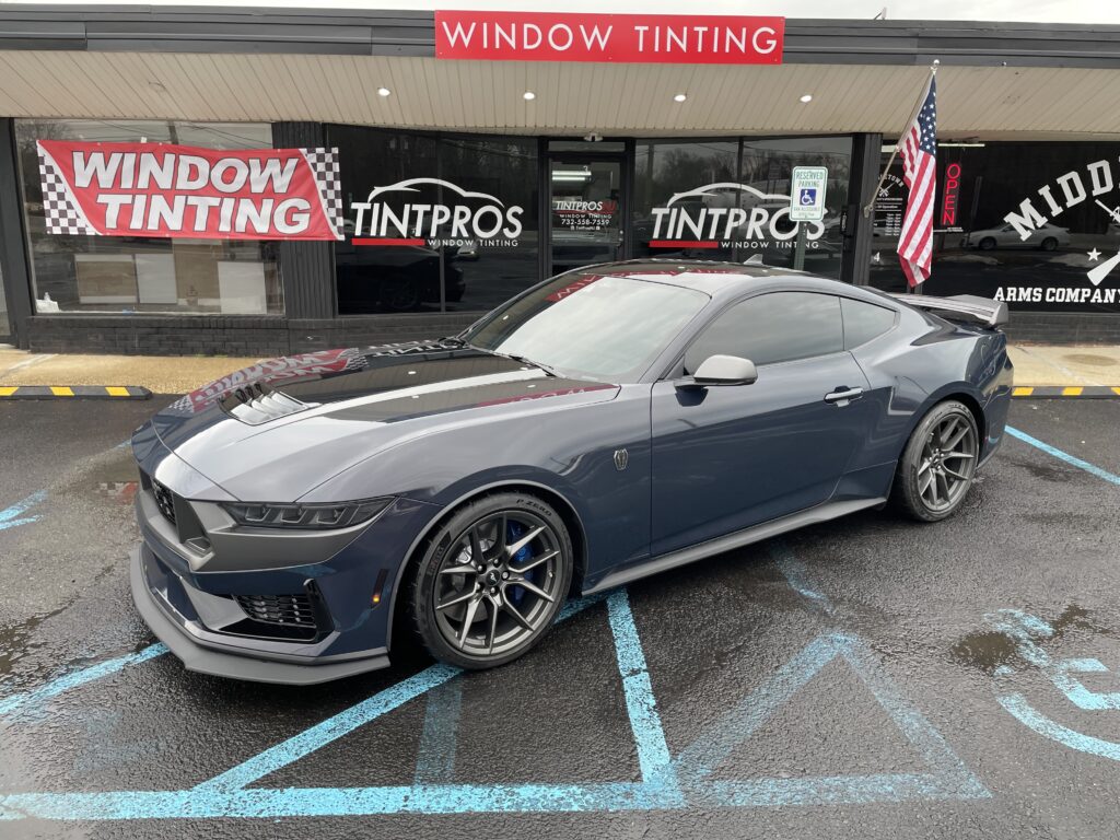 Dark gray sports car with window tinting installed at TintProsNJ shop in Port Monmouth, NJ